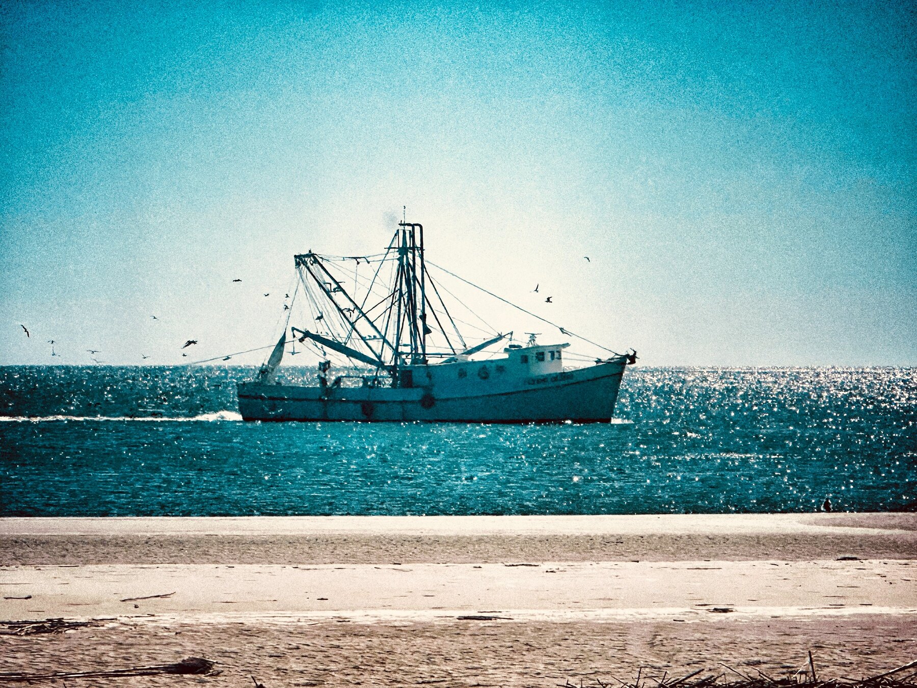A shrimp boat working in the waters off Saint Simons Island